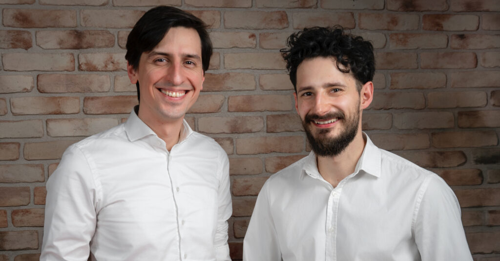 Wojciech Biedziński, Delivery Director, and Przemysław Koper, CEO of Espeo Software, standing together and facing the camera.