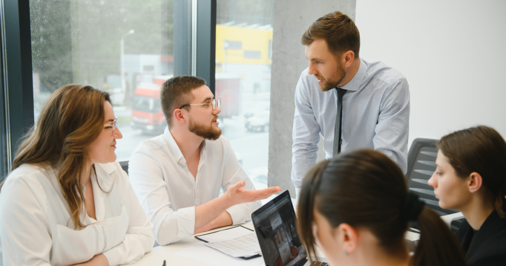 Software development team discussing a financial system integration project during a meeting.