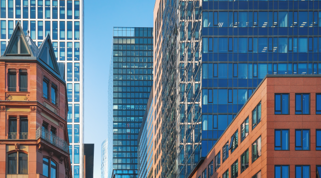 Modern office buildings in a financial district, representing the client organisation in the financial services sector.