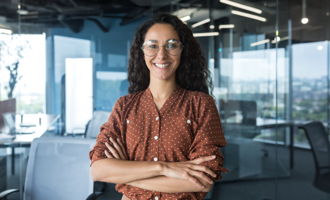 Technology professional standing in a modern office environment, representing a financial sector stakeholder.